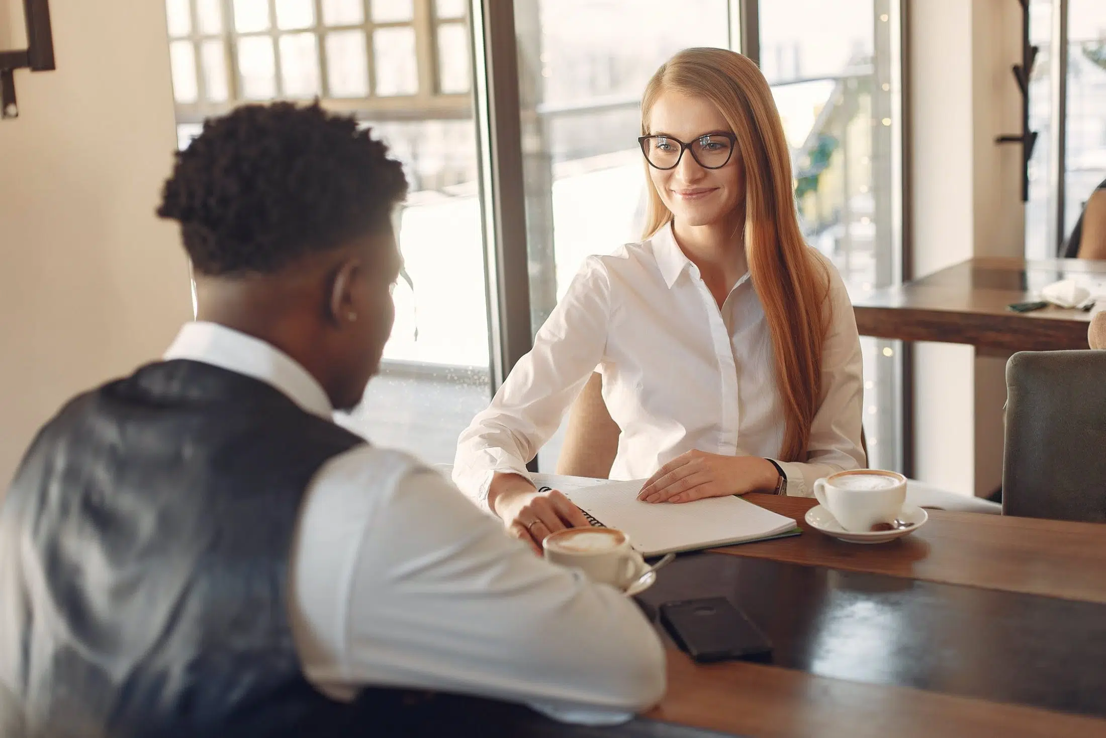 2 people talking across a table