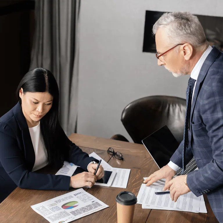 Two people looking at reports
