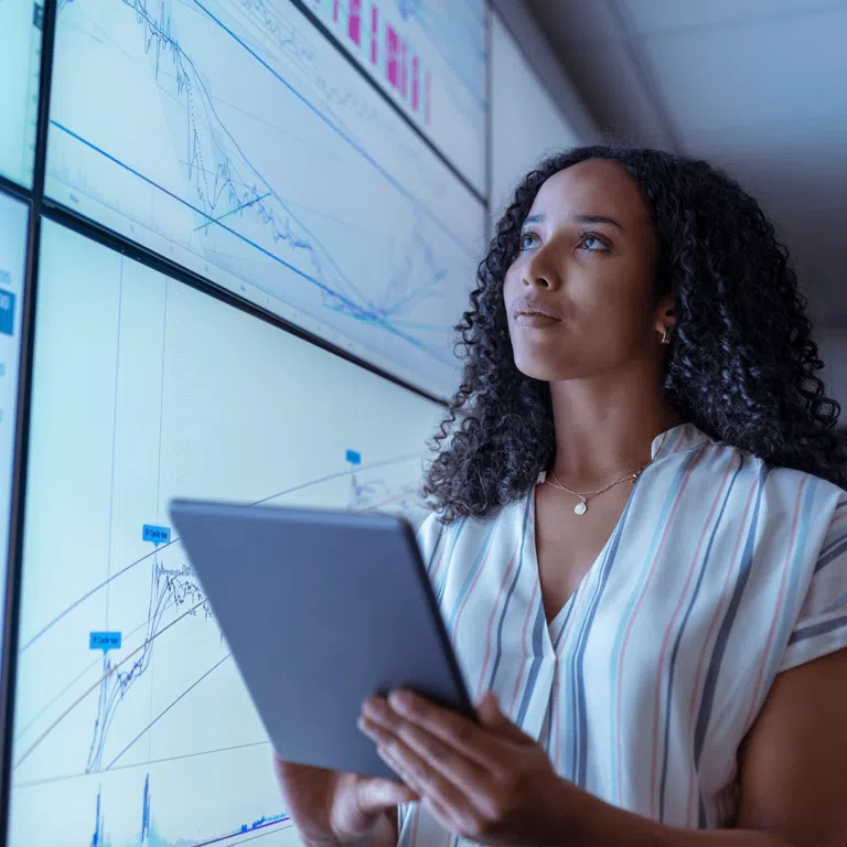 Lady with tablet device looking at tech trends