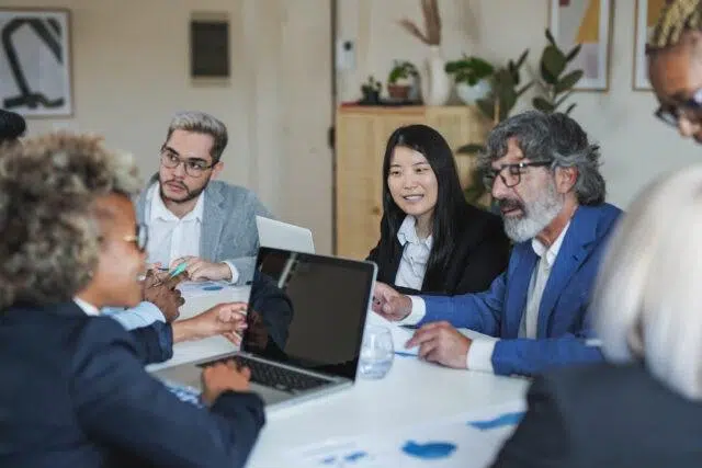 multiracial business people working inside meeting