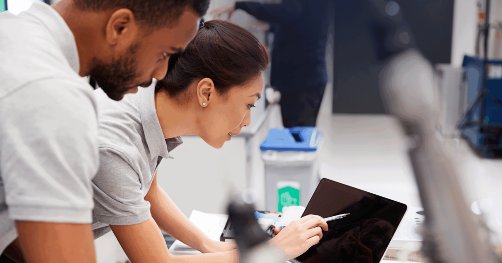 Man and women looking at data on tablet