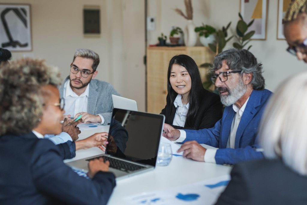Multiracial business people working inside meeting room office