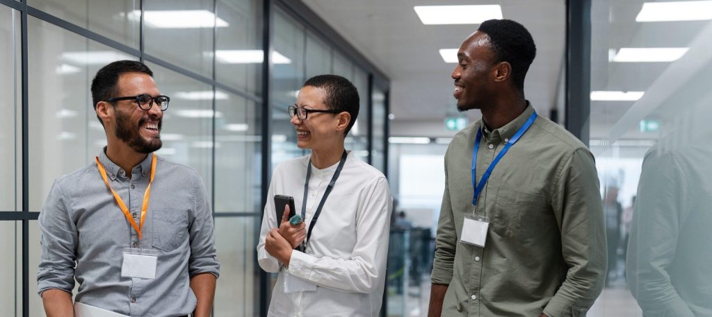 Three people walking in an office setting