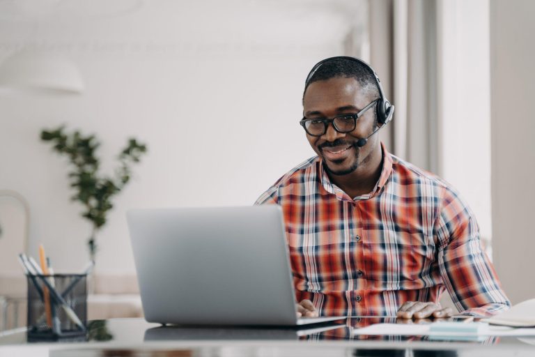 Man using a laptop and headset
