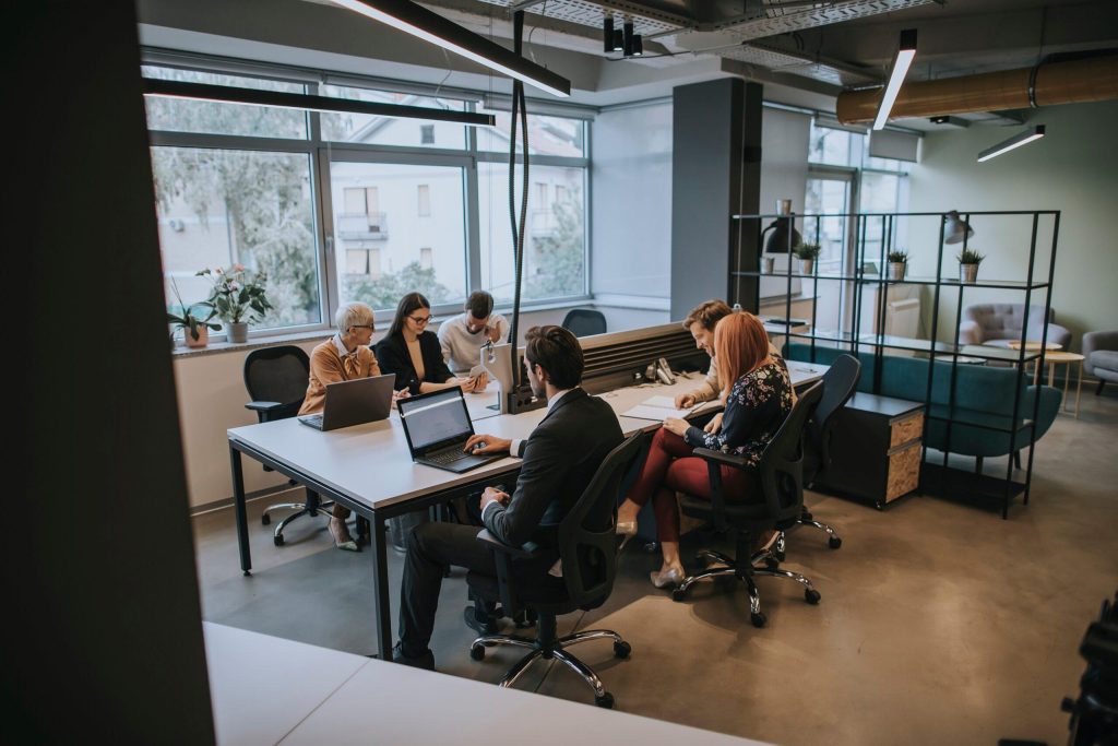 Six people around a table working collaboratively