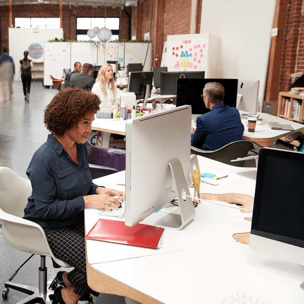 Office employees working at computers in a modern workplace