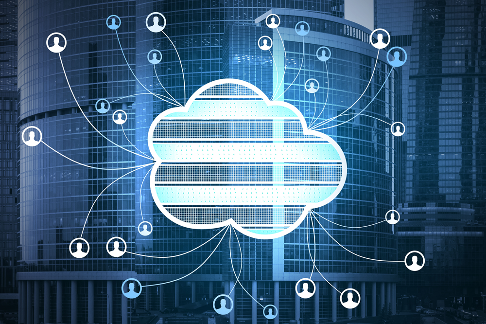 The image presents a detailed and futuristic depiction of cloud computing networks embedded within an urban business environment, where a large, glowing cloud icon occupies the center of the scene and is overlaid on top of modern skyscrapers with glass facades, suggesting a corporate city setting; the cloud is designed with horizontal segmented lines and bright cyan illumination, giving it a digital, layered appearance, and from this central cloud multiple thin, curved connection lines extend outward in all directions, linking to numerous small circular icons that each contain simplified user profile symbols, representing individual users or devices connected to the network; these icons are evenly distributed across the frame, creating a web-like structure that spans the image and conveys a sense of widespread connectivity and data sharing; the background buildings are slightly blurred and tinted in deep blue tones, emphasizing the digital overlays and enhancing depth, while the overall color palette consists of cool blues, whites, and subtle gradients with glowing highlights that reinforce a high-tech aesthetic; the composition clearly communicates the concept of centralized cloud infrastructure supporting a distributed network of users, symbolizing themes of data exchange, collaboration, remote access, and interconnected digital ecosystems in a modern technological landscape.