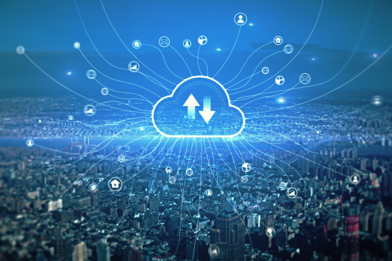 The image presents a wide, aerial view of a densely built modern cityscape stretching across the entire lower half of the frame, captured under a cool blue color tone that gives the scene a sleek, technological atmosphere, while dominating the center of the composition is a large, glowing cloud icon positioned above the city, outlined in bright cyan light; inside the cloud symbol are two bold arrows—one pointing upward and one downward—clearly representing data upload and download processes, and radiating outward from this central cloud are numerous thin, luminous lines that extend in all directions across the sky and down into the city, visually connecting to multiple small circular icons scattered throughout the scene, each icon representing different digital functions or services such as user accounts, devices, communication tools, and applications; these interconnected lines create a web-like network overlay that integrates seamlessly with the buildings
