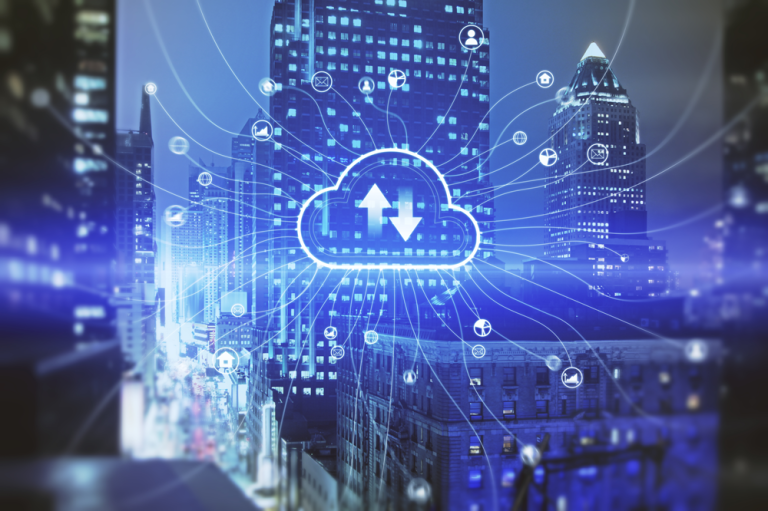 The image depicts an advanced visualization of cloud computing integrated within a modern urban environment at night, where a detailed cityscape featuring illuminated high-rise buildings and busy streets forms the background, while at the center a glowing cloud icon appears prominently, containing two bold arrows—one pointing upward and one downward—symbolizing data upload and download processes; radiating outward from this central cloud are numerous thin, bright lines and connection paths that extend across the entire scene, linking to small circular and icon-based nodes scattered over the buildings, representing various devices, applications, and network endpoints connected to the cloud infrastructure; the city is enveloped in a cool-toned palette dominated by deep blues and purples, with bright cyan highlights emphasizing the digital overlays, while subtle light streaks and reflections enhance the sense of motion and data flow; the relationship between