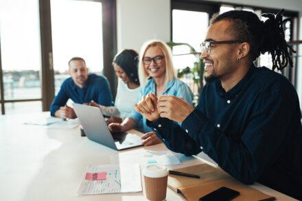 Young African American businessman laughing during an office mee
