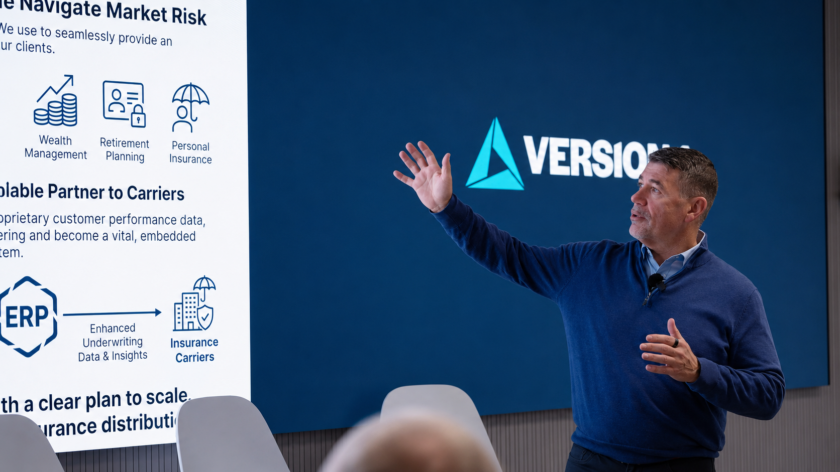 Man presenting in a modern conference room, gesturing toward a large screen displaying financial services icons and text, with a corporate logo on a blue background behind him