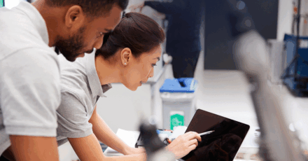 Man and women looking at data on tablet